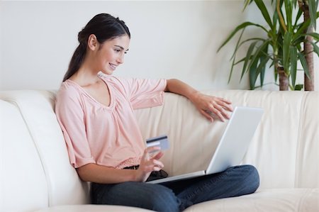 simsearch:400-04410667,k - Delighted woman shopping online in her living room Stock Photo - Budget Royalty-Free & Subscription, Code: 400-05742013