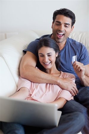 simsearch:400-04410667,k - Portrait of a happy couple booking their holidays online in their living room Stock Photo - Budget Royalty-Free & Subscription, Code: 400-05742034