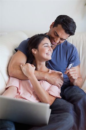 simsearch:400-04410667,k - Portrait of a lovely couple booking their holidays online in their living room Stock Photo - Budget Royalty-Free & Subscription, Code: 400-05742035
