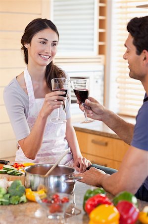 simsearch:400-05740111,k - Portrait of a young couple having a glass of wine while cooking in their kitchen Stock Photo - Budget Royalty-Free & Subscription, Code: 400-05742640