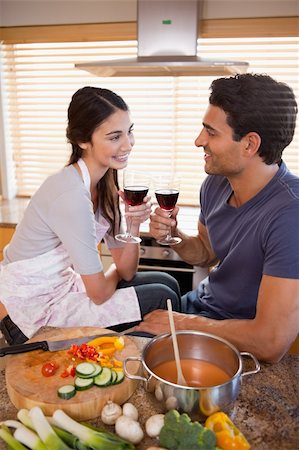 simsearch:400-05740111,k - Portrait of a happy couple having a glass of wine while cooking in their kitchen Stock Photo - Budget Royalty-Free & Subscription, Code: 400-05742641