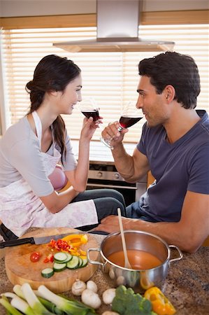 simsearch:400-05740111,k - Portrait of a charming couple having a glass of wine while cooking in their kitchen Stock Photo - Budget Royalty-Free & Subscription, Code: 400-05742642