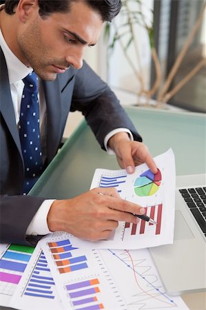 simsearch:400-05748170,k - Portrait of a young sales person studying statistics in an office Stock Photo - Budget Royalty-Free & Subscription, Code: 400-05742756