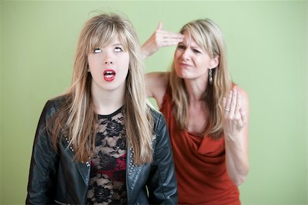 simsearch:400-05918419,k - Frustrated mother behind angry daughter in provocative clothing Stock Photo - Budget Royalty-Free & Subscription, Code: 400-05754655