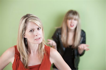 simsearch:400-05918419,k - Angry mother with frustrated daughter in the background Stock Photo - Budget Royalty-Free & Subscription, Code: 400-05754652