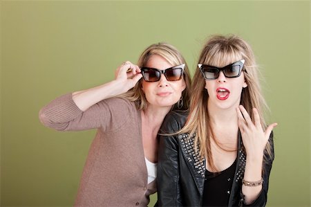 simsearch:400-05918419,k - Caucasian mother and daughter with sunglasses over green background Stock Photo - Budget Royalty-Free & Subscription, Code: 400-05755785