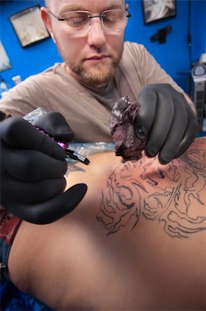 Bearded Caucasian tattooist creates a tattoo on a woman's back Stock Photo - Budget Royalty-Free & Subscription, Code: 400-05755788