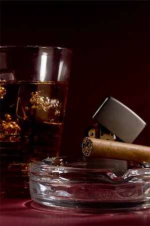 simsearch:400-05207678,k - Close-up selective focus of a brown cigar with a glass of whiskey in the background. Stock Photo - Budget Royalty-Free & Subscription, Code: 400-05750207