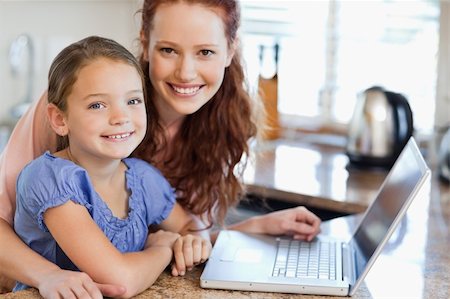 simsearch:400-05751173,k - Mother and daughter together with notebook in the kitchen Stock Photo - Budget Royalty-Free & Subscription, Code: 400-05751176