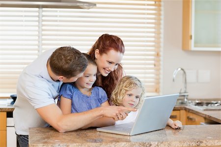 simsearch:400-05751173,k - Family together with laptop in the kitchen Stock Photo - Budget Royalty-Free & Subscription, Code: 400-05751183