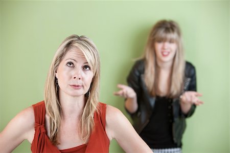 simsearch:400-05918419,k - Disappointed mom with frustrated daughter in background Stock Photo - Budget Royalty-Free & Subscription, Code: 400-05751353
