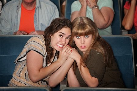 panic and crowd - Two scared women huddle close in a theater Stock Photo - Budget Royalty-Free & Subscription, Code: 400-05751361