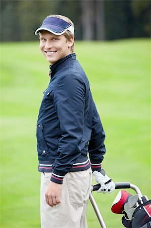 simsearch:400-05753039,k - Smiling golfer on the golf course Photographie de stock - Aubaine LD & Abonnement, Code: 400-05753061