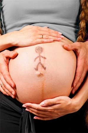 simsearch:400-04866555,k - little man. Male and female hands are embracing stomach of a pregnant woman on gray background with caption on stomach Foto de stock - Super Valor sin royalties y Suscripción, Código: 400-05876122
