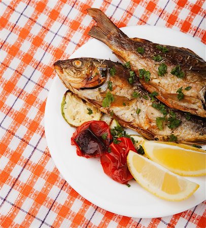 edible picture of fish - A plate with fried fish, vegetable and lemon Stock Photo - Budget Royalty-Free & Subscription, Code: 400-05876749