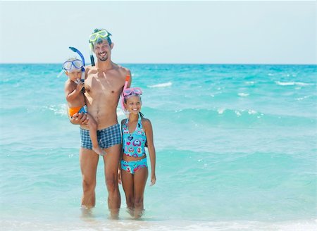 Happy young father with her child with snorkeling equipment on sandy tropical beach Stock Photo - Budget Royalty-Free & Subscription, Code: 400-05877581