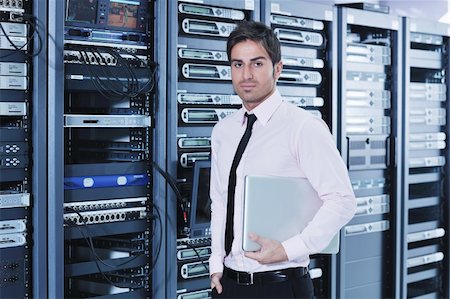 simsearch:400-05881495,k - young engeneer business man with thin modern aluminium laptop in network server room Stock Photo - Budget Royalty-Free & Subscription, Code: 400-05878614