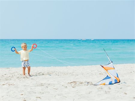 pictures of boy fly kites in the sky - Little cute boy playing with a colorful kite on the tropical beach. Stock Photo - Budget Royalty-Free & Subscription, Code: 400-05879037