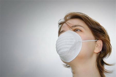 Woman wears protective mask against flu or pollution Stock Photo - Budget Royalty-Free & Subscription, Code: 400-05879181