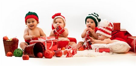 santa children - Four cute babies in xmas costumes playing among gifts Stock Photo - Budget Royalty-Free & Subscription, Code: 400-05879856