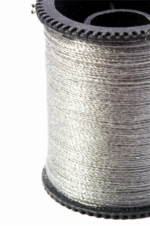 simsearch:6109-08701535,k - Close-up photograph of silver thread spool on a white background. Stock Photo - Budget Royalty-Free & Subscription, Code: 400-05887702