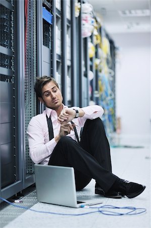 simsearch:400-05881495,k - young engeneer business man with thin modern aluminium laptop in network server room Stock Photo - Budget Royalty-Free & Subscription, Code: 400-05881504
