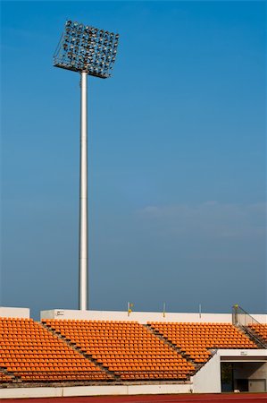 Contemporary stadium Orange seat light and track with blue sky Stock Photo - Budget Royalty-Free & Subscription, Code: 400-05881709