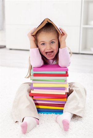 Little girl scared of school sitting with lots of books Stock Photo - Budget Royalty-Free & Subscription, Code: 400-05882474
