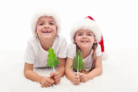 red lollipop - Kids with candy at christmas time smiling on the floor Stock Photo - Budget Royalty-Free & Subscription, Code: 400-05882494