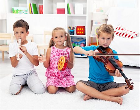 picture of young boy holding violin - Our first band - Kids playing on musical instruments Photographie de stock - Aubaine LD & Abonnement, Code: 400-05882511