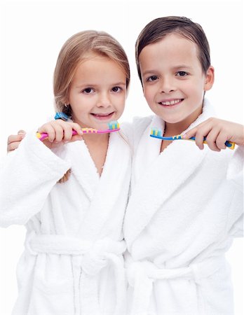 simsearch:400-04151137,k - Beautiful kids preparing to brush their teeth wearing white bathrobes - isolated, closeup Photographie de stock - Aubaine LD & Abonnement, Code: 400-05882578