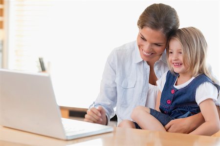 simsearch:400-05751173,k - Mother and her daughter using a laptop in their kitchen Stock Photo - Budget Royalty-Free & Subscription, Code: 400-05894683