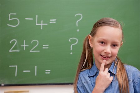 simsearch:625-01250891,k - Cute schoolgirl thinking in front of a blackboard Stock Photo - Budget Royalty-Free & Subscription, Code: 400-05894747