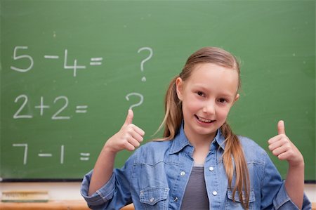 simsearch:625-01250891,k - Smiling schoolgirl with the thumbs up in front of a blackboard Stock Photo - Budget Royalty-Free & Subscription, Code: 400-05894750