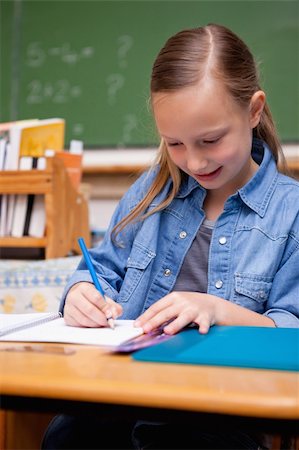 simsearch:400-05896357,k - Portrait of a schoolgirl writing in a classroom Stock Photo - Budget Royalty-Free & Subscription, Code: 400-05895034