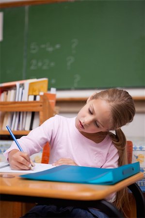 simsearch:400-05896357,k - Portrait of a focused schoolgirl writing in a classroom Stock Photo - Budget Royalty-Free & Subscription, Code: 400-05895039