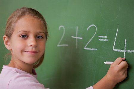 simsearch:625-01250891,k - Smiling schoolgirl writing a number in a blackboard Stock Photo - Budget Royalty-Free & Subscription, Code: 400-05895045