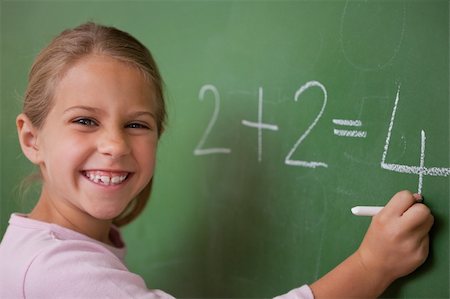 simsearch:625-01250891,k - Happy schoolgirl writing a number on a blackboard Stock Photo - Budget Royalty-Free & Subscription, Code: 400-05895046