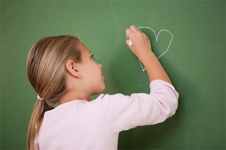 simsearch:400-05896424,k - Schoolgirl drawing a heart on a blackboard Stock Photo - Budget Royalty-Free & Subscription, Code: 400-05895049