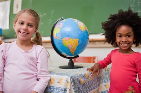 simsearch:400-05357982,k - Cute schoolgirls posing with a globe in a classroom Stock Photo - Budget Royalty-Free & Subscription, Code: 400-05895061