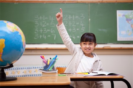 simsearch:400-05896357,k - Smiling schoolgirl raising her hand to answer a question in a classroom Stock Photo - Budget Royalty-Free & Subscription, Code: 400-05895086