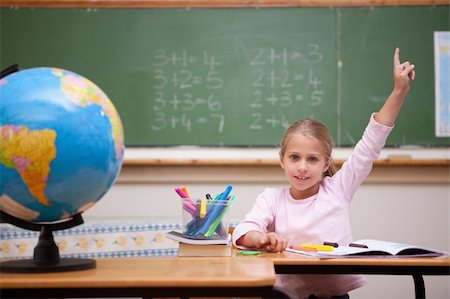 simsearch:400-05896357,k - Cute schoolgirl raising her hand to answer a question in a classroom Stock Photo - Budget Royalty-Free & Subscription, Code: 400-05895087
