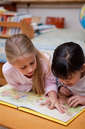 simsearch:400-05896357,k - Portrait of schoolgirls reading a fairy tale in a classroom Stock Photo - Budget Royalty-Free & Subscription, Code: 400-05895096