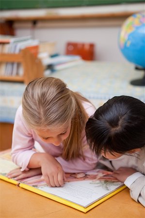 simsearch:400-05896357,k - Portrait of focused schoolgirls reading a fairy tale in a classroom Stock Photo - Budget Royalty-Free & Subscription, Code: 400-05895097