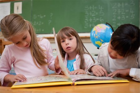 simsearch:400-05896357,k - Cute schoolgirls reading a fairy tale to their classmate in a classroom Stock Photo - Budget Royalty-Free & Subscription, Code: 400-05895102