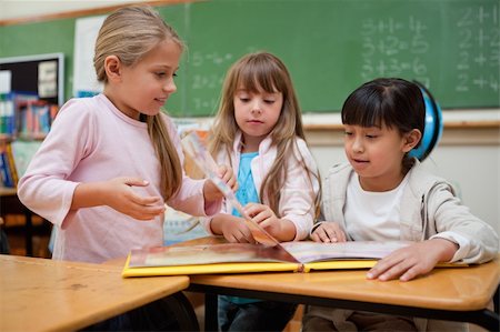 simsearch:400-05896357,k - Little schoolgirls reading a fairy tale to their classmate in a classroom Stock Photo - Budget Royalty-Free & Subscription, Code: 400-05895103