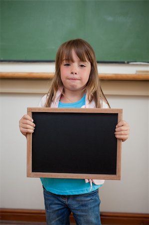 simsearch:400-05896424,k - Portrait of a little girl holding a school slate in a classroom Stock Photo - Budget Royalty-Free & Subscription, Code: 400-05895116