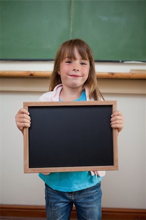 simsearch:400-05896424,k - Portrait of a smiling girl holding a school slate in a classroom Stock Photo - Budget Royalty-Free & Subscription, Code: 400-05895117