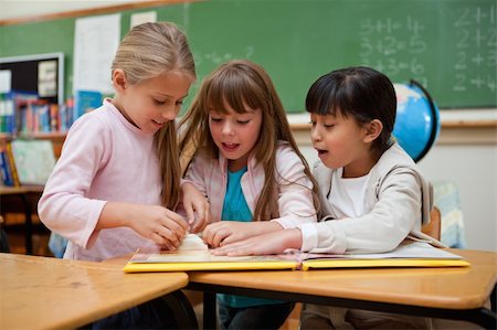 simsearch:400-05896357,k - Little schoolgirls reading a fairy tale in a classroom Stock Photo - Budget Royalty-Free & Subscription, Code: 400-05895111