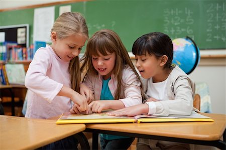 simsearch:400-05896357,k - Little schoolgirls reading a fairy tale together in a classroom Stock Photo - Budget Royalty-Free & Subscription, Code: 400-05895112